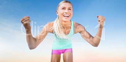 Composite image of portrait of sportswoman smiling and raising a