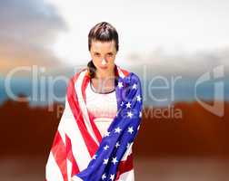 Composite image of portrait of sporty woman holding american fla