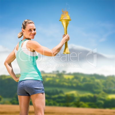 Composite image of woman posing with trophy