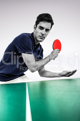 Composite image of confident male athlete playing table tennis