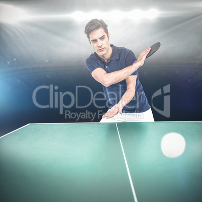 Confident male athlete playing table tennis