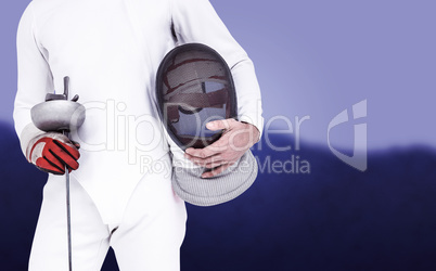 Composite image of swordsman holding fencing mask and sword