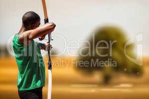 Composite image of rear view of sportsman doing archery on a whi