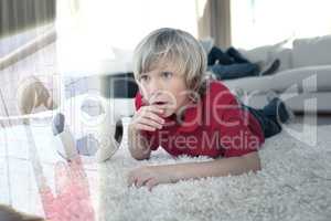 Composite image of cute boy watching soccer match