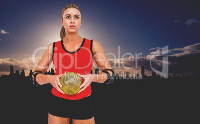 Female athlete with elbow pad holding handball