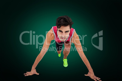 Composite image of portrait of male athlete on starting line