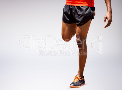 Composite image of athletic man hopping