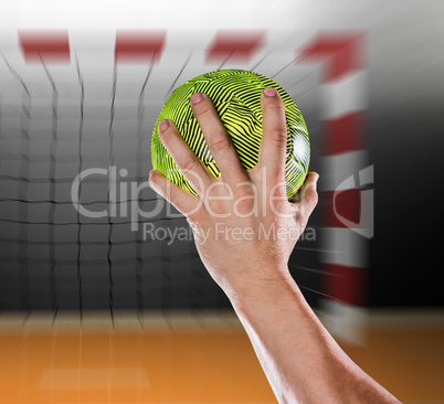 Composite image of sportsman holding a ball