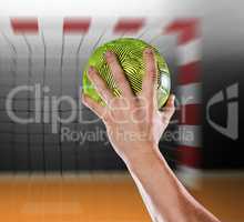 Composite image of sportsman holding a ball