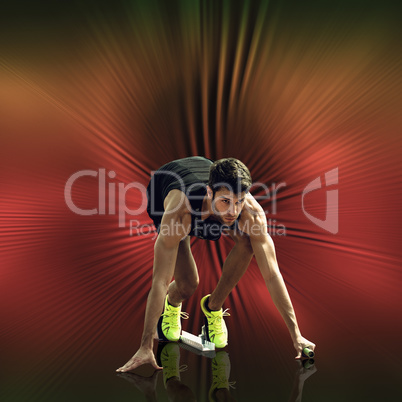 Composite image of sportsman waiting on the starting block