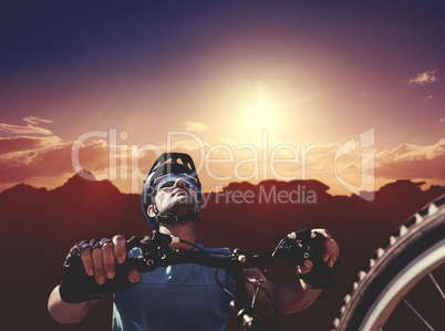 Composite image of man cycling with mountain bike