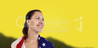 Composite image of athlete with american flag wrapped around his