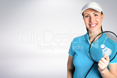 Composite image of badminton player holding badminton racket and