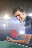 Composite image of portrait of happy male athlete playing table