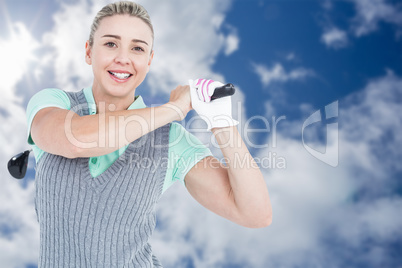 Composite image of pretty blonde playing golf