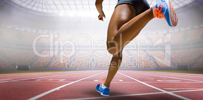 Composite image of sporty woman finishing her run