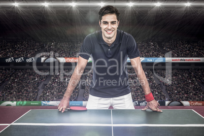 Composite image of confident male athlete leaning on hard table