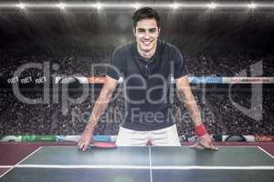 Composite image of confident male athlete leaning on hard table