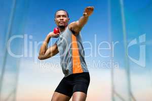 Composite image of front view of sportsman practising shot put