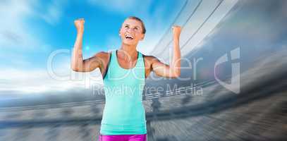 Composite image of athletic woman with arms up