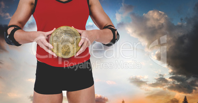 Composite image of female athlete with elbow pad holding handbal