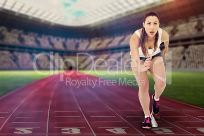 Composite image of athlete woman in ready to run position