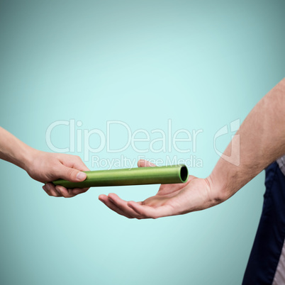 Man passing the baton to partner on track