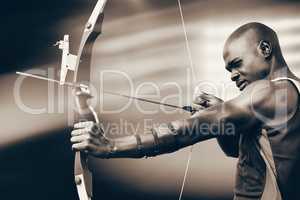 Composite image of side view of sportsman practising archery