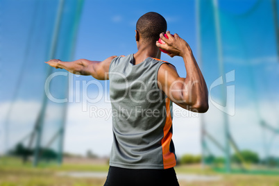 Composite image of rear view of athletic man preparing the shot