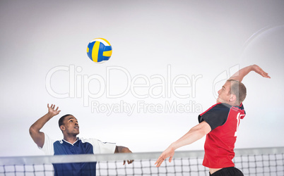 Composite image of sportsman hitting volleyball