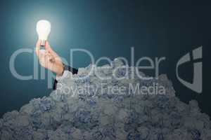 Composite image of hand holding energy saving light bulb