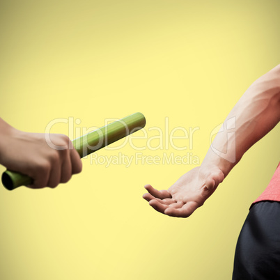 Athlete passing a baton to the partner