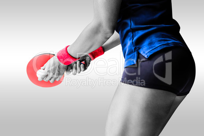 Composite image of female athlete playing ping pong