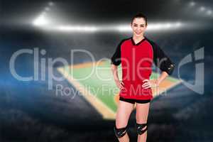 Female athlete posing with elbow pad and knee pad