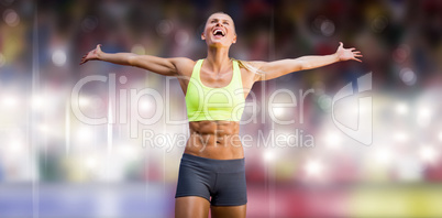 Composite image of fit woman celebrating victory with arms stret