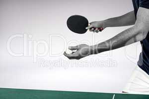 Composite image of male athlete playing table tennis