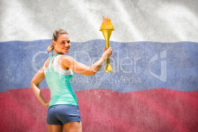 Composite image of woman posing with trophy