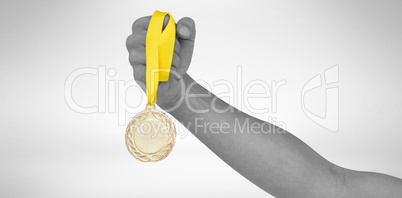 Athlete holding gold medal after victory