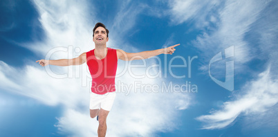 Excited male athlete with arms outstretched