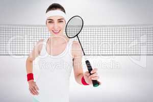 Composite image of badminton player is posing and smiling