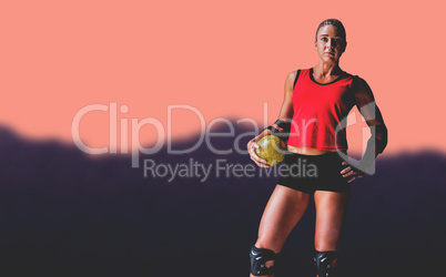 Female athlete with elbow pad holding handball