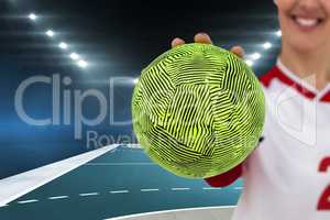 Composite image of sportswoman holding a ball