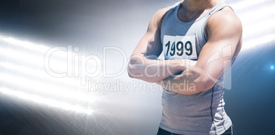 Composite image of handsome sportsman is posing with crossed arm