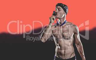 Composite image of swimmer kissing his gold medal
