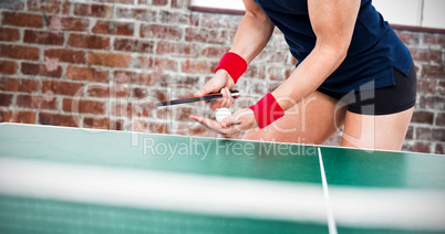 Composite image of female athlete playing ping pong