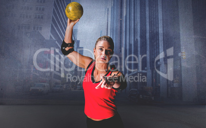 Composite image of female athlete with elbow pad throwing handba