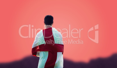 Composite image of rear view of sportsman holding an england fla