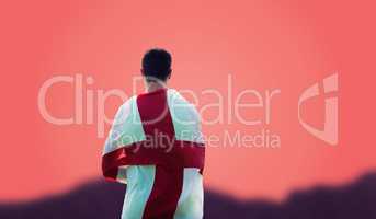 Composite image of rear view of sportsman holding an england fla