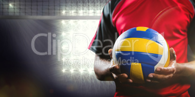 Composite image of mid-section of sportsman holding a volleyball