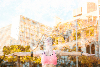 Composite image of a beautiful athlete stretching her arms